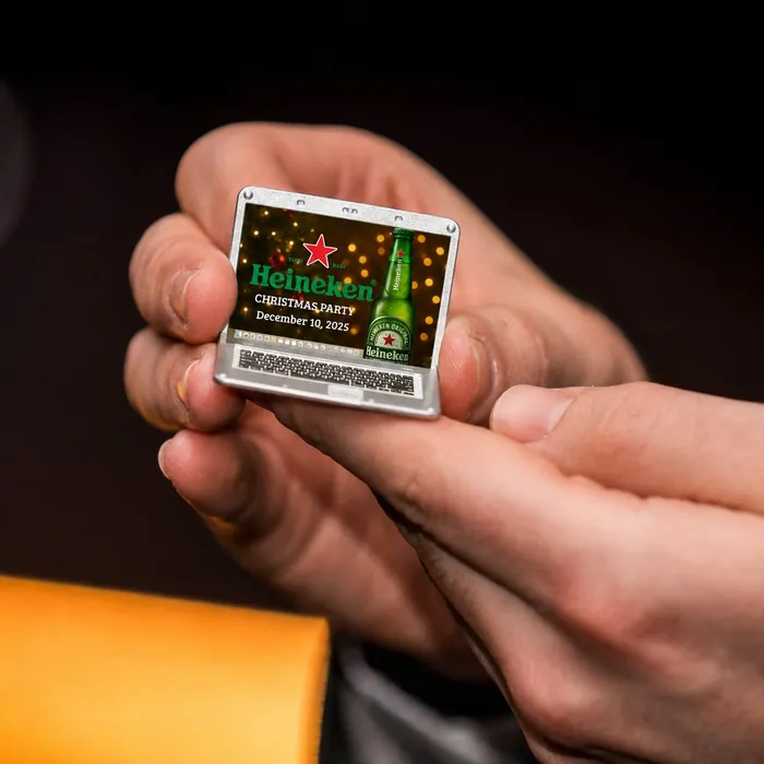 A mini laptop souvenir with Heineken’s Christmas party on its screen