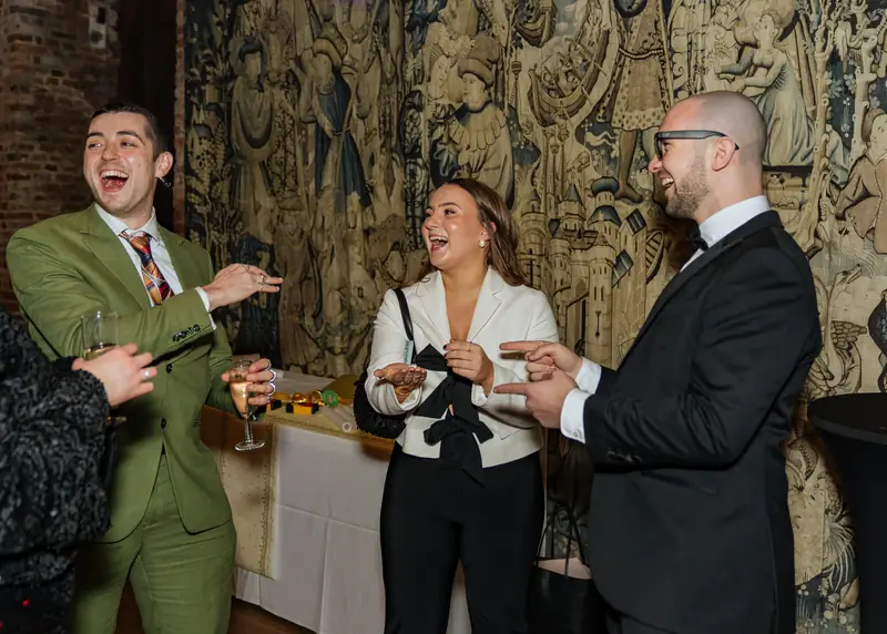 Guests laughing during interactive magic at Hatfield House