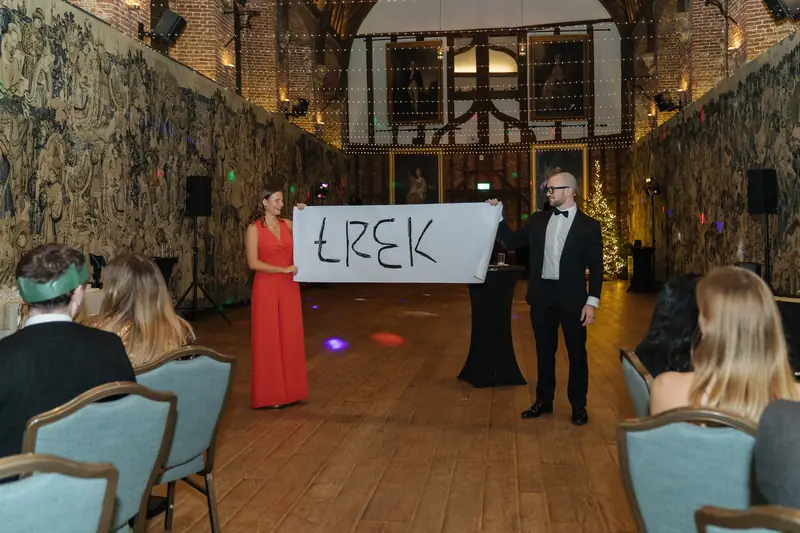 A guest helping with a big reveal in front of the whole room at Hatfield House