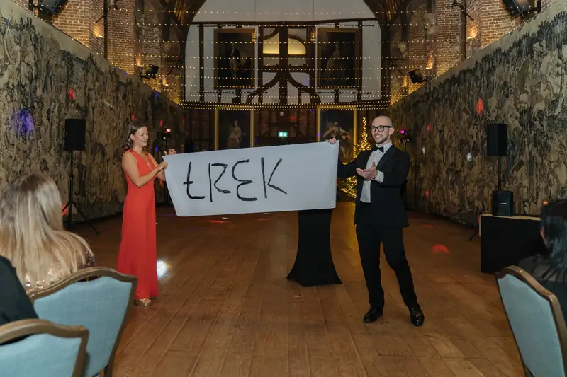 Magician and guest mid-trick at the Lotus Christmas party