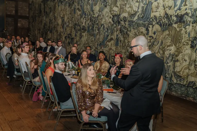 Daniel Bower performing at the tables during the Christmas dinner at Hatfield House