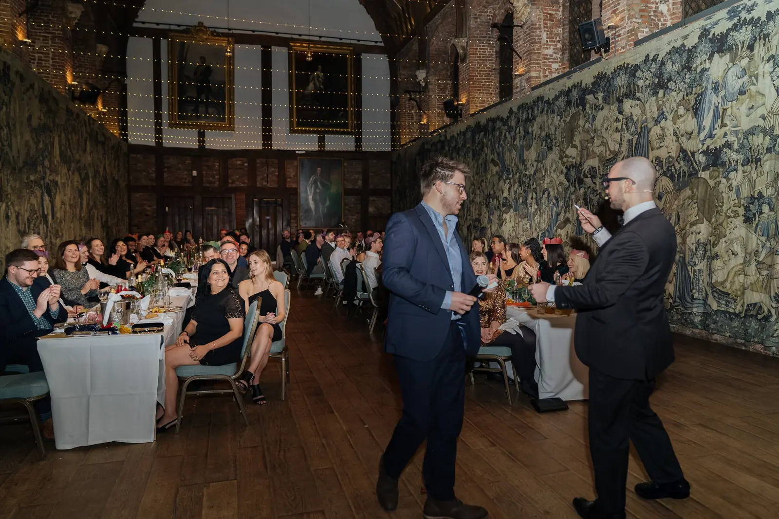 A guest joining Daniel Bower in front of the whole room at the Lotus Christmas party, Hatfield House