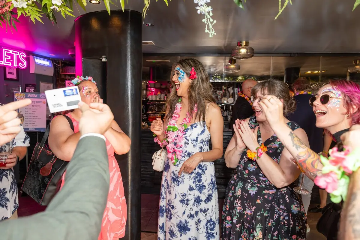 Daniel Bower performing close-up magic for guests at an event