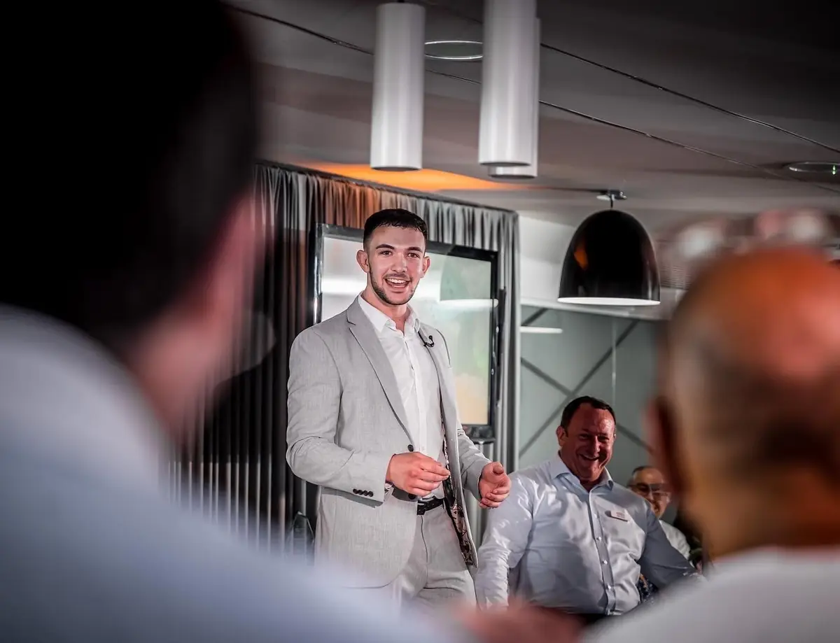 Magician performing for corporate guests at indoor event.