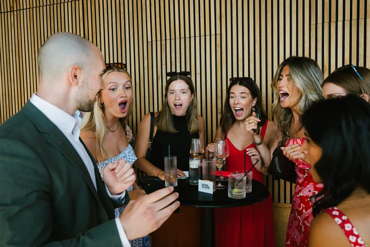 Daniel Bower performing close-up magic for guests at an event