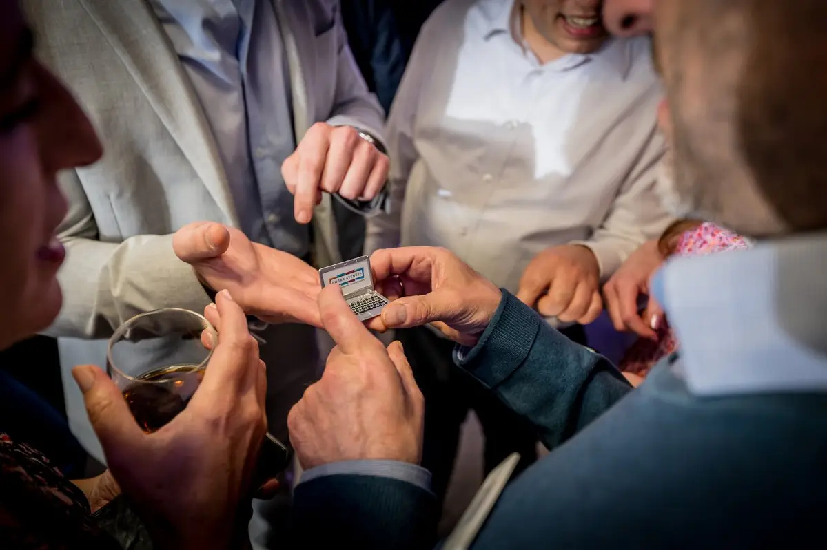 Magician used trick card during corporate event.
