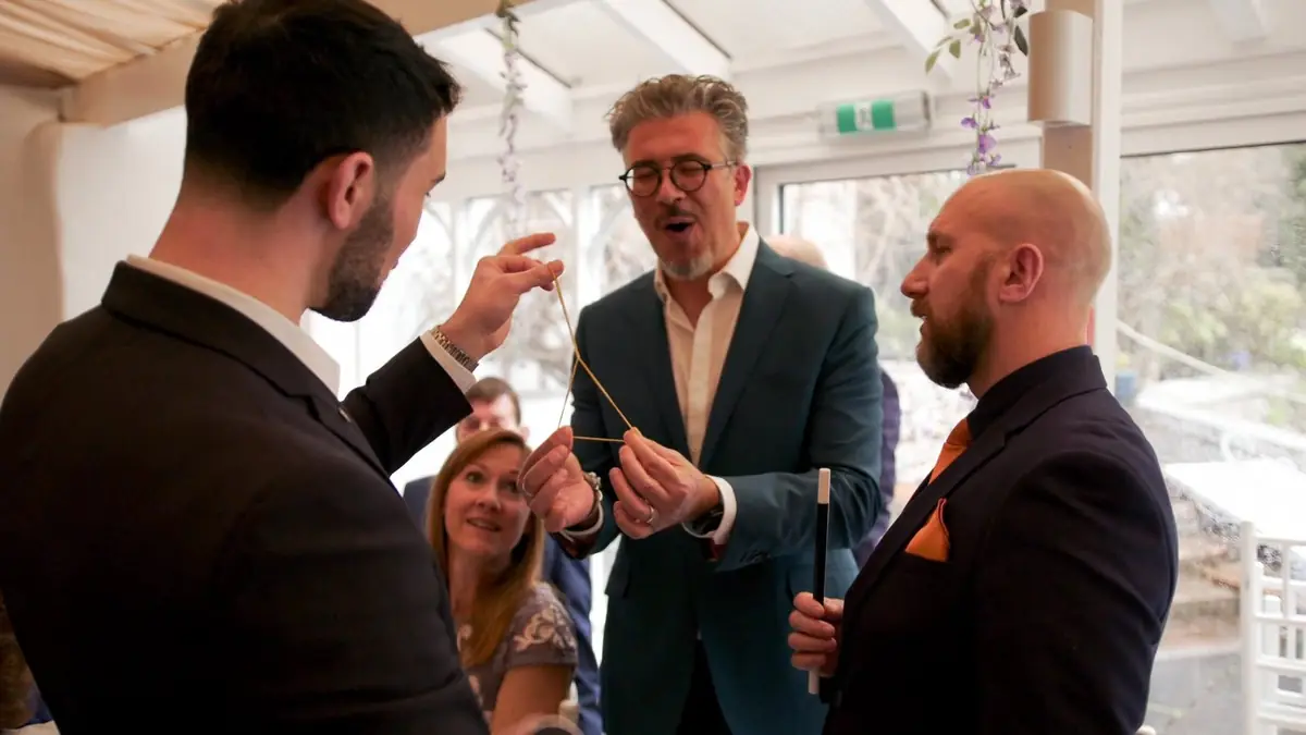 Daniel Bower performing close up magic for a group of guests