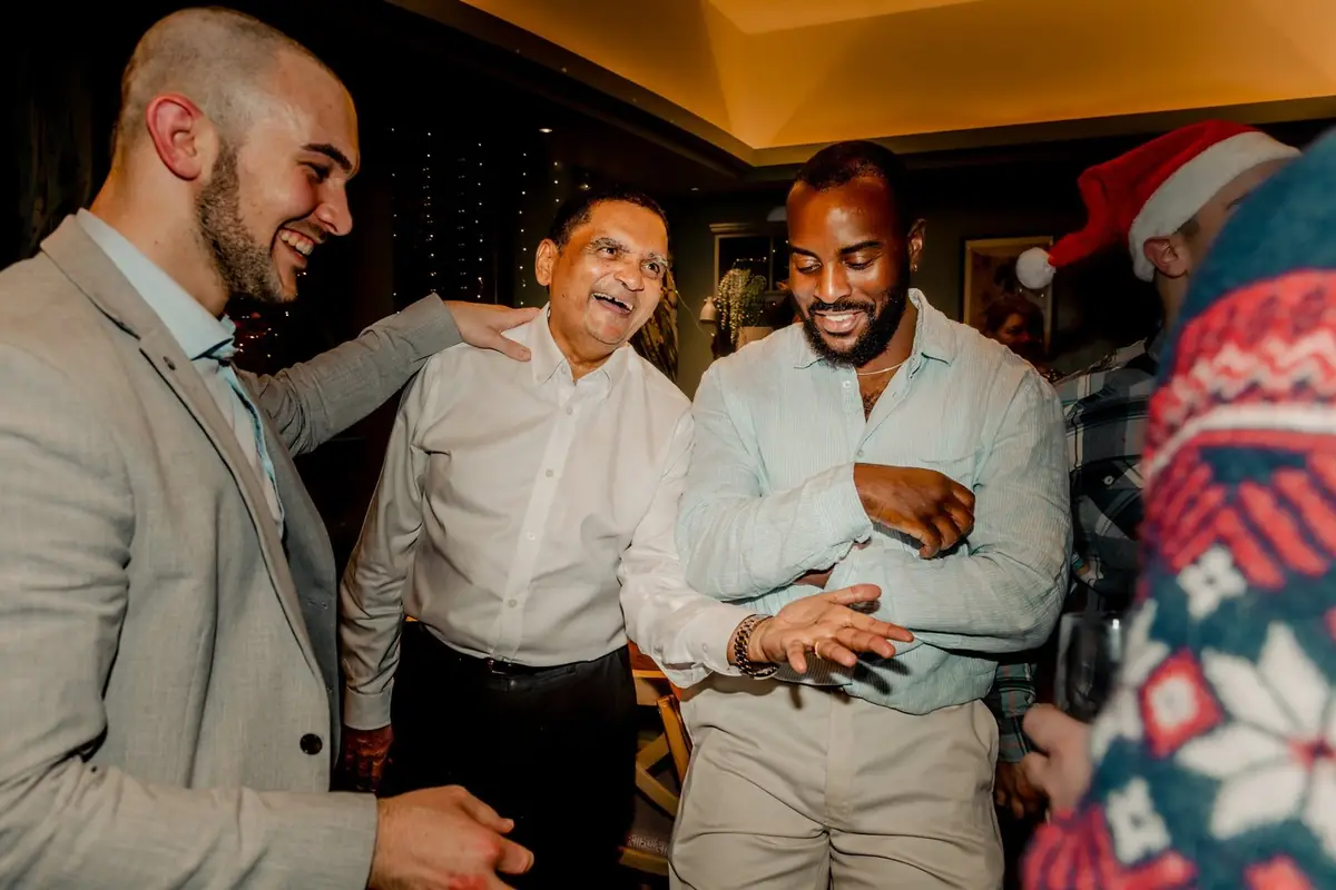 Magician engaging guests in close-up magic, creating joyful moments.