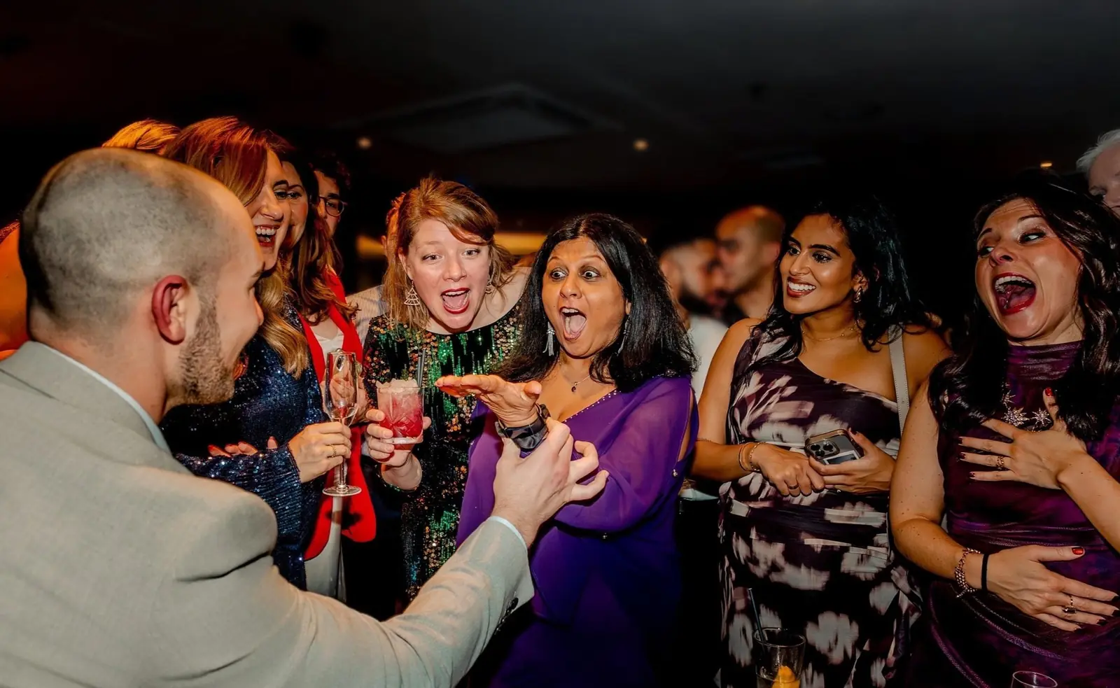 Guests enjoying Daniel Bower’s interactive magic at a corporate event.